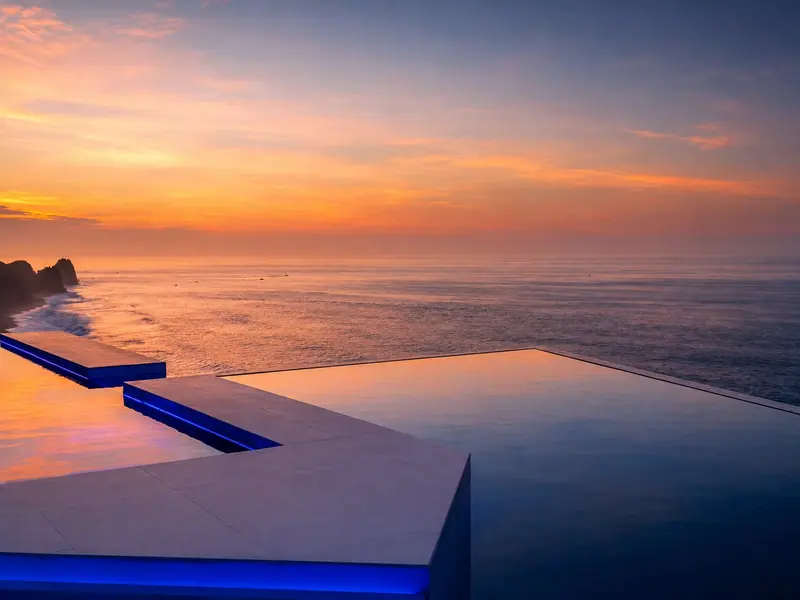 Infinity pool at Villa Lands End reflecting a Cabo sunset