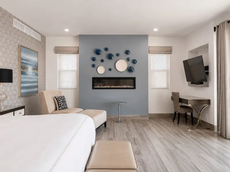 Primary suite at Villa Lands End with fireplace, king bed, and oceanfront terrace
